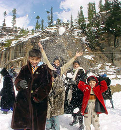 Tourists enjoy at the Manali-Rohtang Pass road which has been closed down due to heavy snowfall.