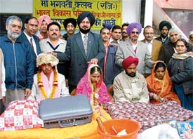 The marriages of poor girls being solemnised at Gurdwara Singh Sabha in Ludhiana on Sunday