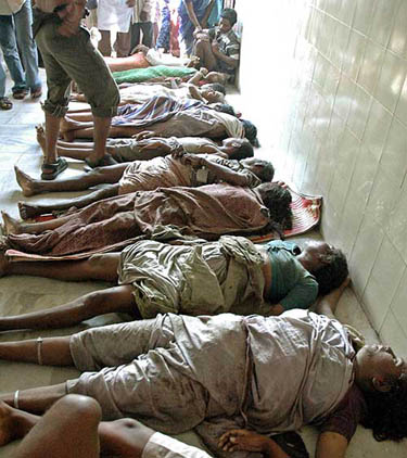 A man looks at bodies lying inside a hospital after a tsunami hit the southern Indian city of Chennai on December 26.  Reuters