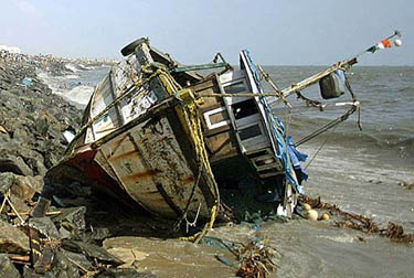 A fishing boat keels over after a tsunami that killed more than 9,000 persons in South Asia hit Chennai on December 26.  Reuters
