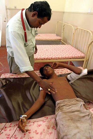 A young Sri Lankan flood victim receives treatment at the Thanamalvila Hospital in southern Sri Lanka on December 26, 2004. Thousands of Sri Lankans abandoned their flooded homes and fled to higher ground on Sunday after the worst tsunami in living memory swamped the island's south and east coast.  Reuters
