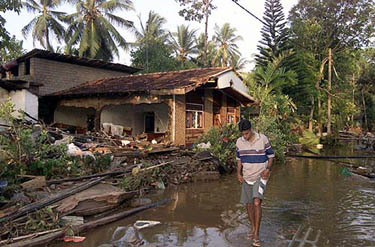 A man walks through what is left of his home after a massive tsunami wave swept across coastal Sri Lanka on December 26.  Reuters
