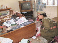 A police officer inspects the scene of crime in a house in Parmanand Nagar in the Capital on Monday.