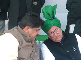 Haryana Chief Minister Om Prakash Chautala discusses a point with his son and Rajya Sabha member Ajay Chautala at a training camp for INLD workers in Hisar on Monday