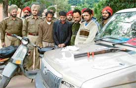 Alleged robbers with some of the recovered vehicles in Ludhiana on Monday