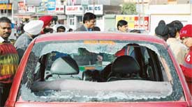 The broken windscreen of a car that was damaged the gateman downed the level crossing gate in Ludhiana on Monday