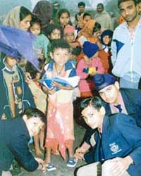 Students of Ryan International School, Ludhiana, distribute clothes among poor children