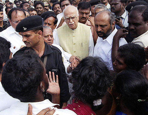 BJP president L. K. Advani listens attentively to grievances of people affected by tsunami waves at Marina beach in Chennai, on Monday.  PTI
