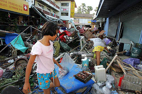 Thai people go through ruins left after devastation caused by tidal waves at Pathong beach, near Phuket, on December 27.  Reuters