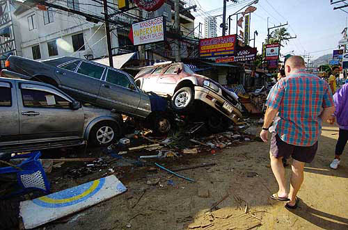 A foreigner inspects the damage done by the December 26 earthquake-triggered tidal waves which hit the island of Phuket, Thailand, a day after the tragedy.  AP/PTI