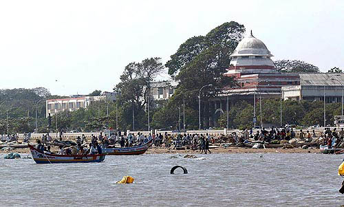 Local residents try their hand at boating in an artificially created pond by tsunami waves, at Marina beach in Chennai on Monday.  PTI