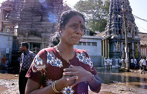 A woman cries after reviewing the destruction on Monday after tidal waves destroyed her house on the coastal areas in Colombo, Sri Lanka, on December 26.  AP/PTI