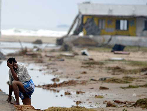 A man reacts next to a building that was destroyed when a tsunami hit on Sunday in Cuddalore, 180 km south of Chennai, on December 27. India's weather bureau on Monday warned that more tsunamis could strike the coast over the next couple of days, but said those would be smaller than the giant tidal wave triggered by an earthquake that killed thousands across Asia.  Reuters