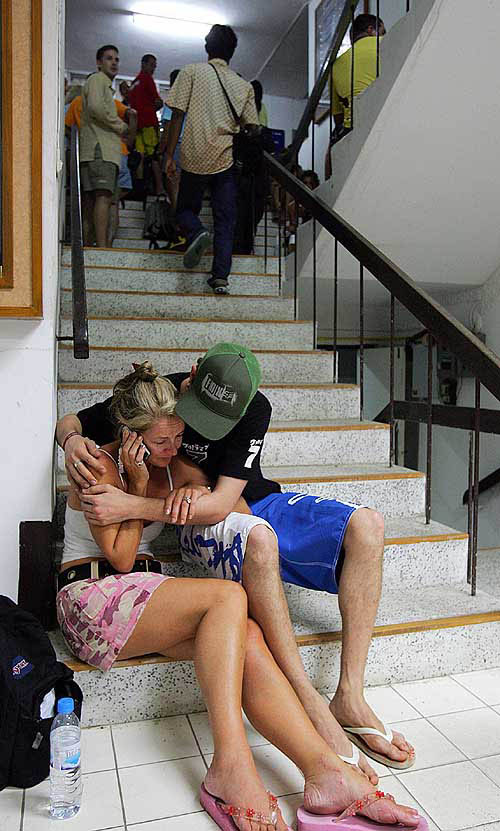 A British tourist talks on the phone as she waits at Phuket city hall, after surviving a devastating tsunami which hit the resort town of Phuket on December 26. One of the most powerful earthquakes in history hit Asia on Sunday, unleashing a tsunami which devastated coastal areas of Sri Lanka, India, Indonesia and tourist isles in Thailand, killing more than 20,000 persons.  Reuters