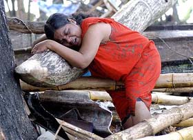 A Sri Lankan woman laments for her missing son and father in Galle, some 125 km south of the Sri Lankan capital Colombo