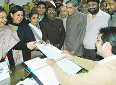 The Congress candidate, Ms Anu Chatrath (second from left), smiles as she files her nomination papers in Chandigarh on Tuesday.