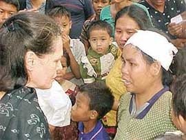UPA Chairperson Sonia Gandhi listens to the woes of an injured tribal woman at Carnic, on Monday.