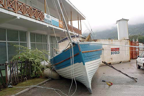 A boat lies in a road in Victoria town, Mah Island in the Seychelles, following surges in the water level after an earthquake off the Indonesian island of Sumatra sent devastating tsunami waves across the Indian Ocean on Sunday, in this photograph taken on December 27. Nations on the Indian Ocean from Indonesia to Sri Lanka searched amongst the wreckage of a devastating tsunami for bodies to bury on Tuesday.  Reuters