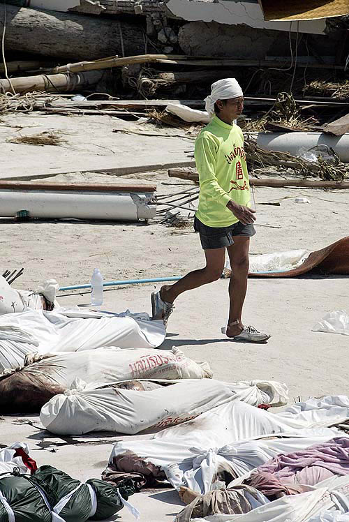 A rescue worker walks past body bags in Ton Sai Bay in Thailand's Phi Phi island on December 28 after a tsunami hit the area two days ago.  Reuters