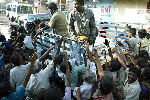 Rescue workers distribute food and clothes among affected people on December 28, two days after tsunami hit Nagapattinam, 350 km south of Chennai.  Reuters