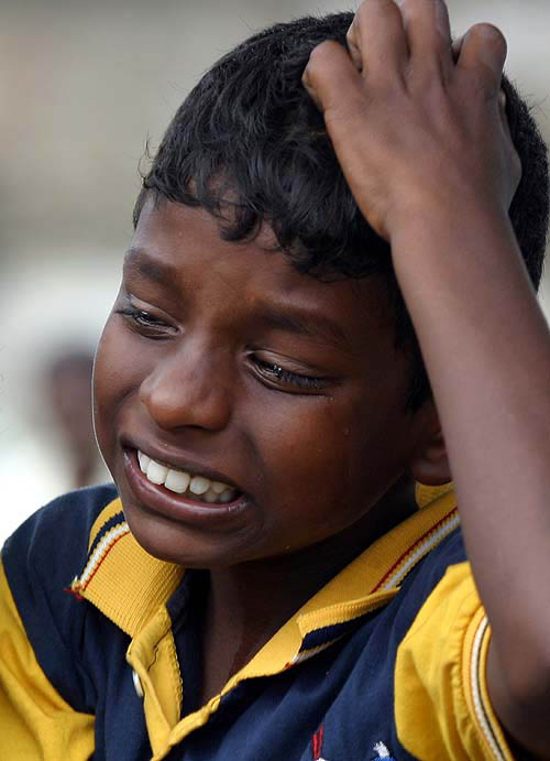 Asitha Fernando, a nine-year-old Sri Lankan boy, mourns the death of his mother in Koralawella, south of Colombo on December 28. His mother was killed when a tsunami hit the area on Sunday.  Reuters