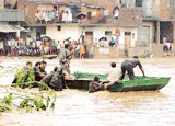 Marooned residents of Rajiv Colony, Panchkula, look for hope as Army personnel try to reach them in a boat