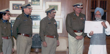 Director-General of CRPF J . K. Sinha presenting a cheque of Rs 4.40 crore to Prime Minister Manmohan Singh towards PM's National Relief Fund for rescue and rehabilitation of tsunami-affected people.