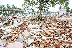 People walk through debris from Sundays tsunami in Hambantota, Sri Lanka, on Wednesday. 