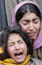 Two Kashmiri women wail on the death of their father Nazir Ahmad in a firing incident which killed three others at Tral in Pulwama district of south Kashmir on Wednesday. 