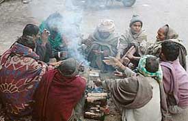 Migrants brave cold with fire in Ludhiana on Wednesday.
