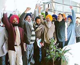 Opposition councillors raise slogans outside the Municipal Corporation building