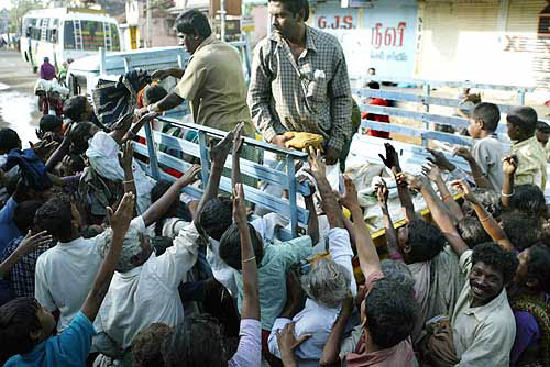 Indian rescue workers distribute food and clothes among flood affected people after tsunami hit Nagapattinam, 350 km south of Chennai on December 28.  Reuters
