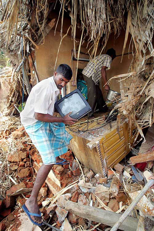Local residents salvage household items from their house which was destroyed by Sunday's tsunami in Cuddalore, 180 km south of Chennai, on December 29.  Reuters