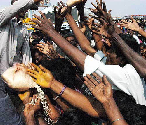 Indian tsunami survivors receive rice at a relief camp in Chennai on December 29, after the area was hit by a tsunami on Sunday.  Reuters