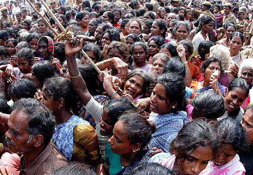 Indian tsunami survivors wait to collect dresses donated by a volunteer organisation at a relief camp in Chennai on December 29, after the area was hit by a tsunami on Sunday.  Reuters