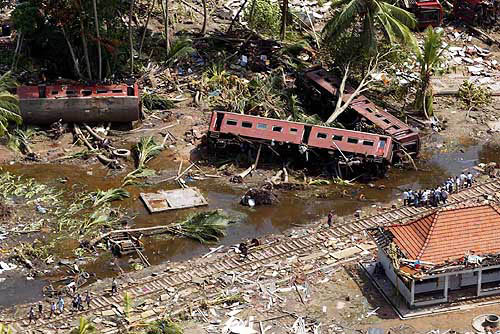 An aerial shot taken from a helicopter shows villagers search for the missing along railroad tracks at Telwatte, about 100 kilometers south of Colombo, Sri Lanka, on December 29. The massive tidal waves that slammed into Sri Lanka flung a train off its tracks, leaving many of its 1,000 passengers dead or missing, the police said on Tuesday. Rescue workers reported another 3,009 deaths from Sunday's earthquake-triggered tsunami, lifting Sri Lanka's toll to 21,715, said the National Disaster Management Centre.  AP/PTI