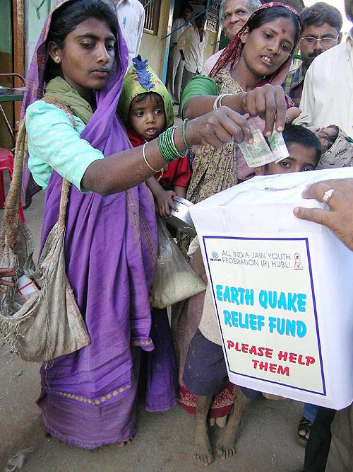 Rag-pickers moved by the havoc of tsunami waves contribute to the relief fund in Hubli on Monday.  PTI