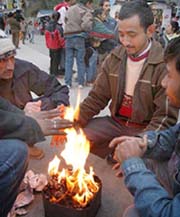Beating the chill: People warm up at Lakkar Bazar in Shimla on Thursday.