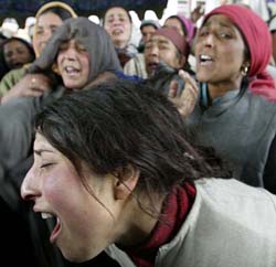 Women wail over the death of two persons in an attack by unidentified militants at Wathoora in Badgam district of central Kashmir on Thursday. 