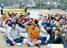 Teachers stage a dharna outside the Deputy Commissioners office in Ludhiana on Thursday