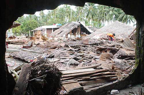 People search for family through destroyed houses at Sirombu village in Nias, North Sumatra, Indonesia, on December 29. Government estimates put the death toll from Sunday's earthquake and tsunami at nearly 50,000 in Indonesia alone.  AP/PTI