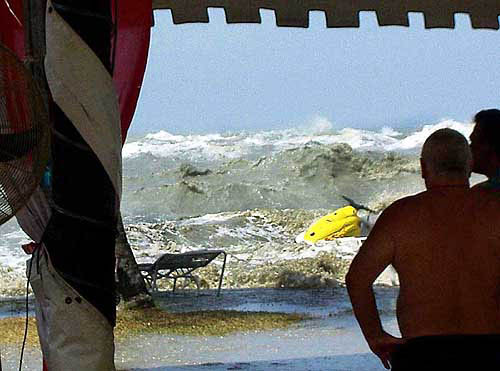 In this photo taken by a tourist Eric Skitzi from England, tourists on a safety place inside Casuarina Beach Hotel looks at the tsunami waves hit at the shore of a resort in Penang, northwestern Malaysia, at around 1 pm in local time (0500GMT) on December 26. The resort hotel lifeguards noticed waves were huge and sounded warning to all tourists around the hotel beach area to run to the safety area. The Malaysian government on Wednesday cancelled New Year celebrations nationwide, urging people to pray this weekend that the country will be spared from future disasters such as the recent tsunamis that killed at least 65 Malaysians.  AP/PTI