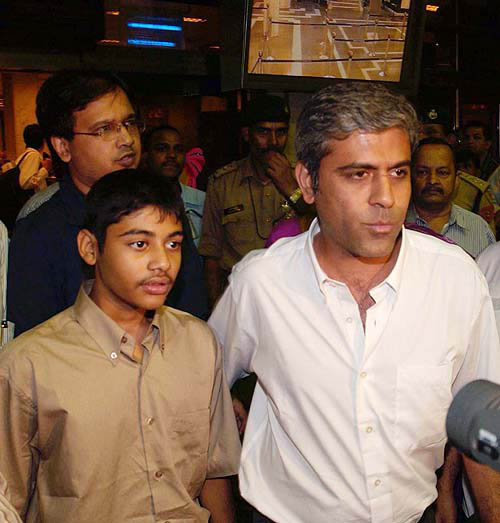 Tushar Shah with his son, Pariket, who survived the killer tsunami when he was vacationing at Phuket in Thailand, arrives at the Mumbai airport on Wednesday night. His wife was, however, washed away in the tsunami tidal waves.  PTI