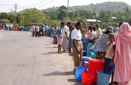 Survivors queue up at a village near Port Blair on December 30 for drinking water, as the basic infrastructure has gone haywire after the tsunami waves struck Andamans and Nicobar island.  PTI