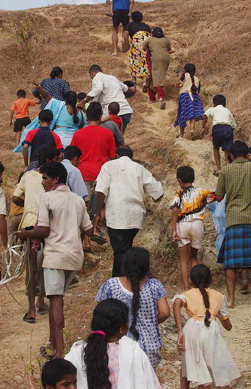 Fearing another tidal wave, survivors of the earlier tsunami tragedy move to the highlands for safety, in Port Blair on Thursday.  PTI