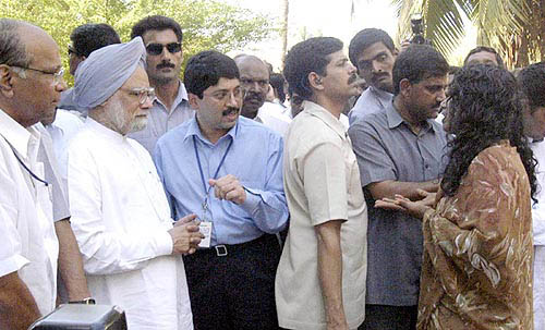 Prime Minister Dr Manmohan Singh and his Cabinet colleagues listen to a womans woes at a relief camp for tsunami victims at Colachal in Kanyakumari on Thursday.  PTI