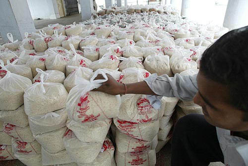 Rice and grain bags are hoarded in an Ahemdabad godown on Thursday. These will be sent by a special train to Chennai for tsunami-hit persons there.  PTI