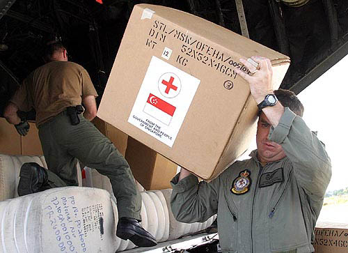 An Australian soldier unloads medical supplies from Singapore for victims of Sunday's tsunami on the tarmac of Banda Aceh airport on December 29. One of the most powerful earthquakes in history hit Asia on Sunday, unleashing a tidal wave which devastated coastal areas of Sri Lanka, India, Indonesia and tourist isles in Thailand, killing tens of thousands of people.  Reuters
