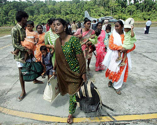 Villagers walk on a runway as they wait to be evacuated from Cambal Bay, in southeastern Andaman and Nicobar islands on December 29, after a quake-triggered tidal wave hit the area on Sunday.  Reuters