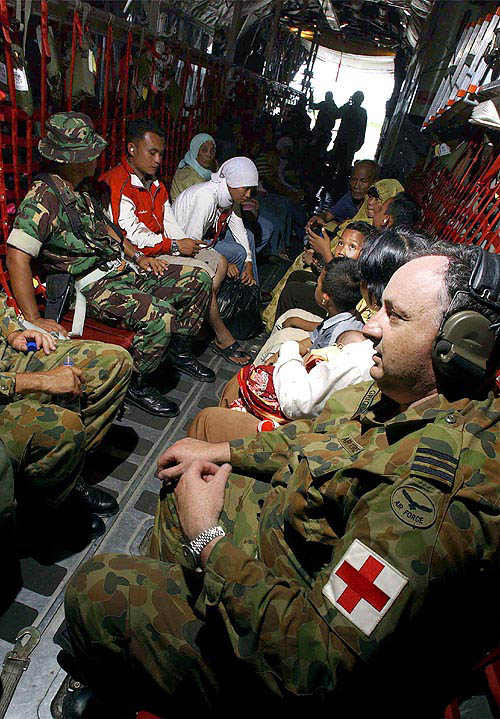 A medical officer sits aboard a Royal Australian Air Force C-130 Hercules on December 29 with more than 100 displaced persons they picked up from the Indonesian city of Banda Aceh. Two Australian C-130 planes delivered humanitarian aid and medical assessment teams to the devastated city after Sunday's quake-triggered tidal wave. One of the most powerful earthquakes in history hit Asia on Sunday, unleashing a tsunami which devastated coastal areas of Sri Lanka, India, Indonesia and tourist isles in Thailand, killing tens of thousands of people.  Reuters